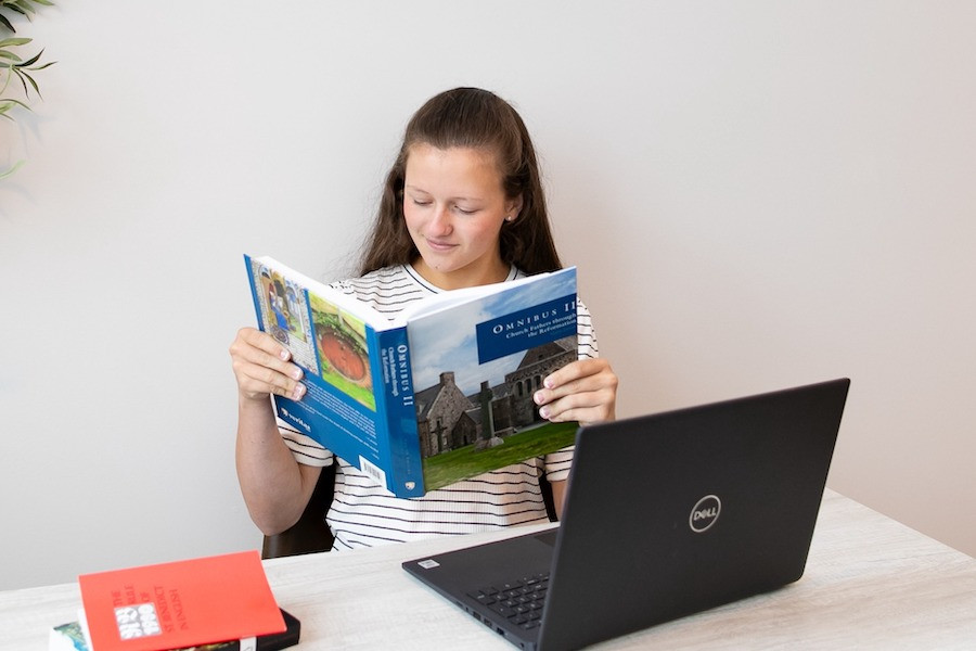 Veritas Scholars Academy A Veritas Scholars Academy student reads from an Omnibus text for her live online class.